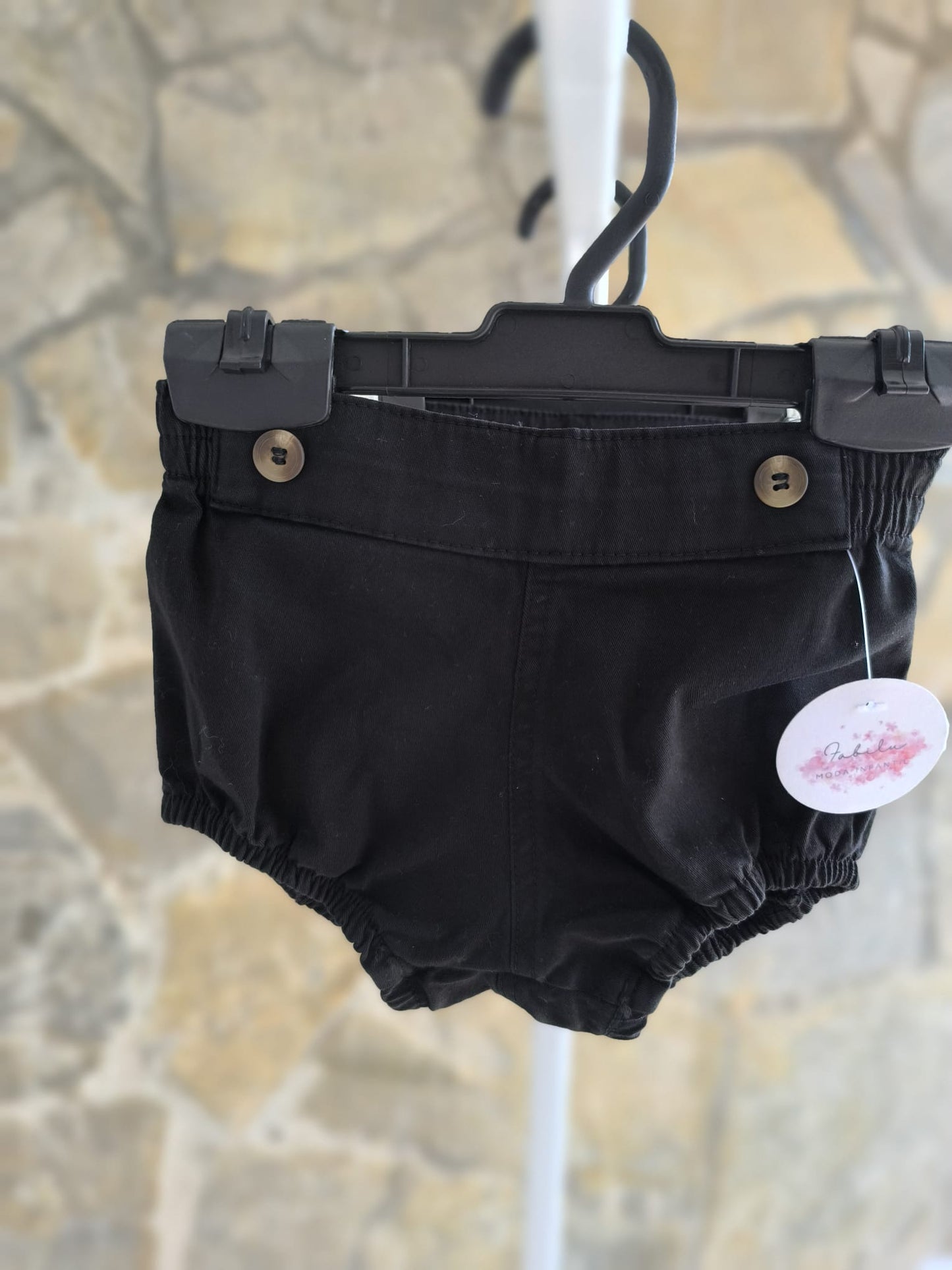 Ranita de bebé en color negro unisex con elástico suave y botones decorativos